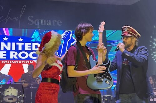 United We Rock Foundation participant receiving a guitar on stage